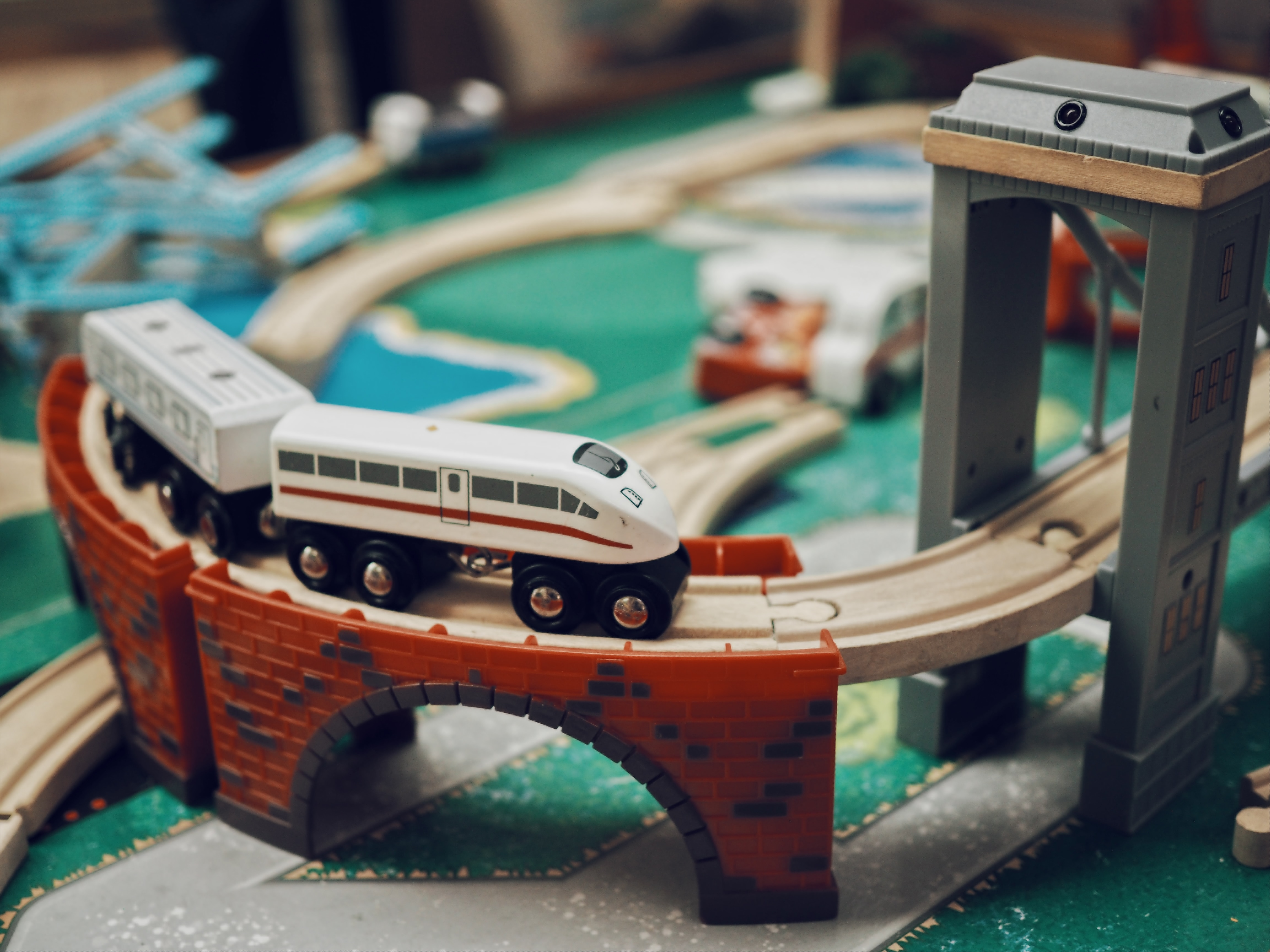 A wooden toy train on a toy bridge